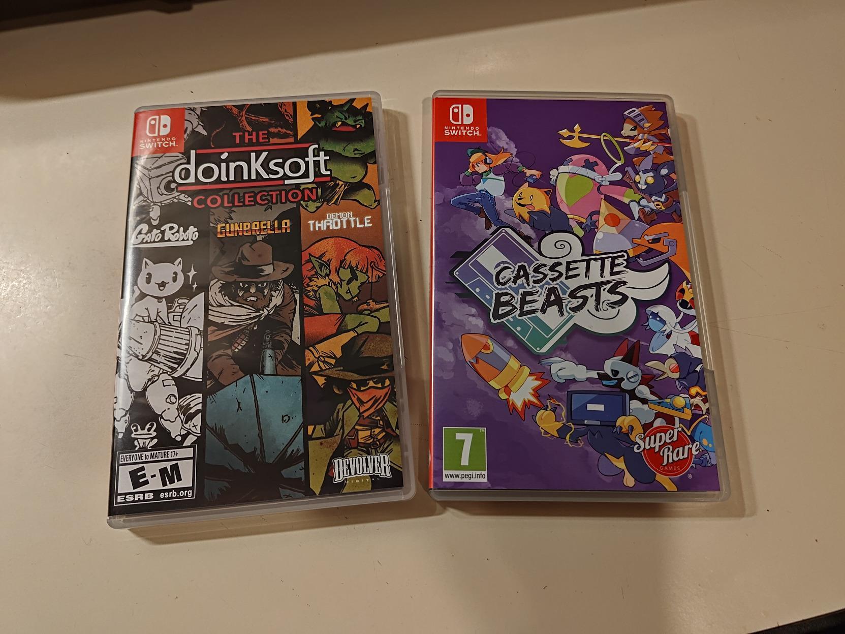 A copy of the Doinksoft Collection, which includes Gato Roboto, Gunbrella and Demon Throttle, and a copy of Cassette Beats for Switch on a counter.