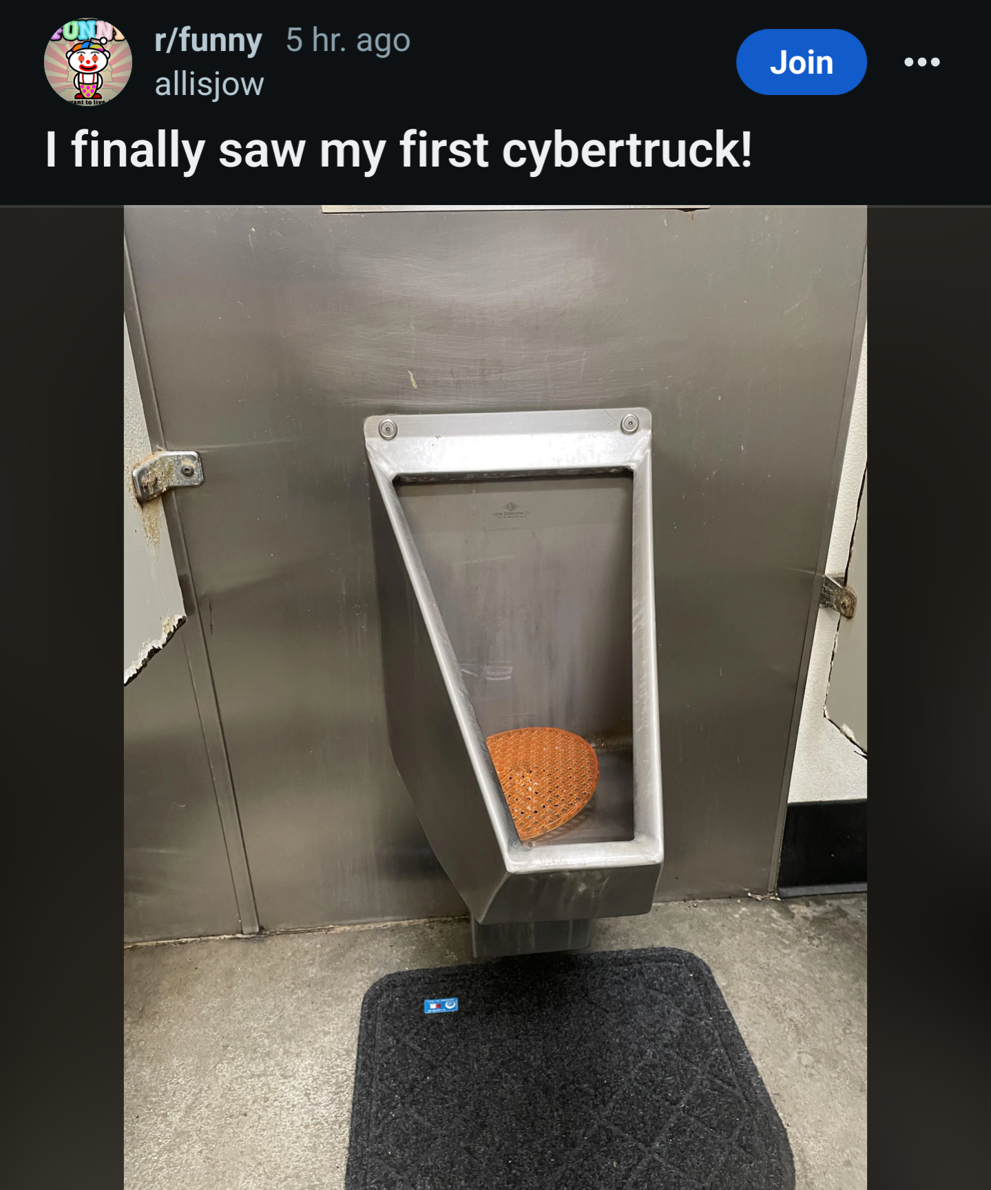 Very square looking urinal made out of stainless steel. Caption
“I finally saw my first cybertruck”